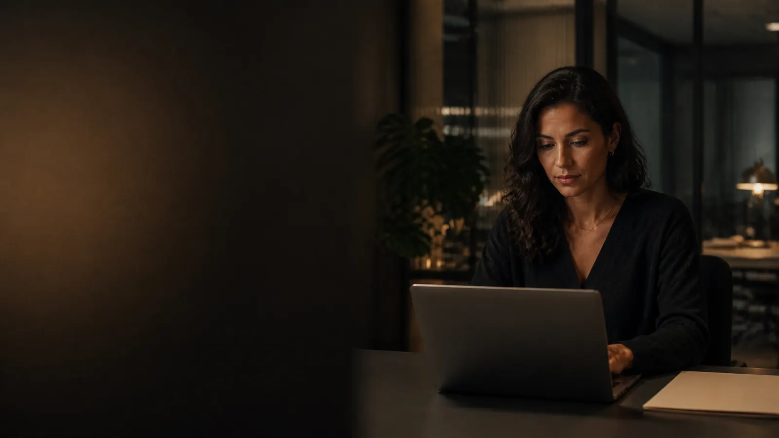 A founder working at a laptop in an office.