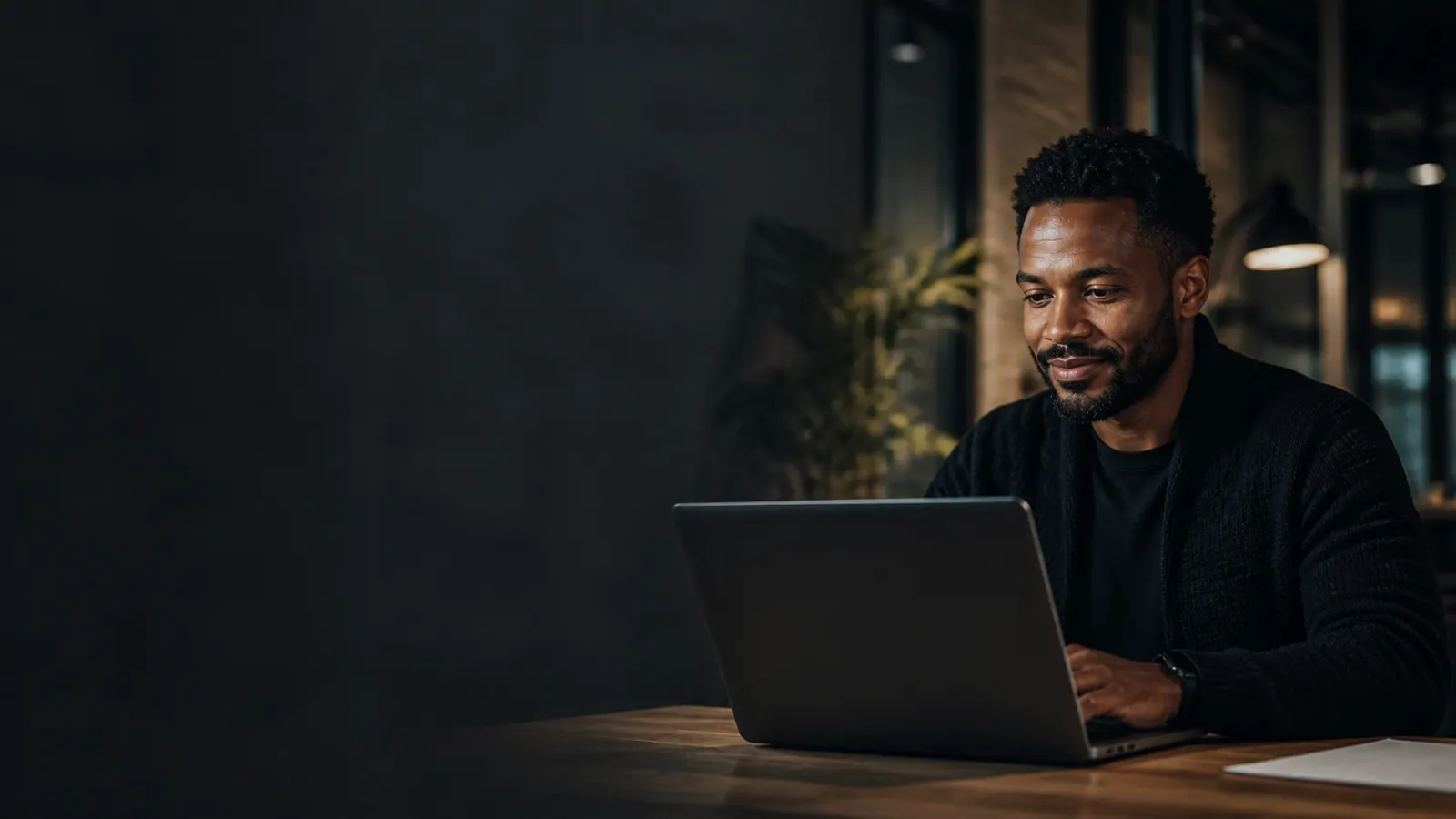 A founder reviewing work on a laptop in an office.